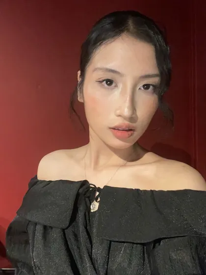 Lily in an off-shoulder black top