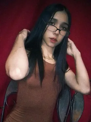 Nataly in glasses against a red wall