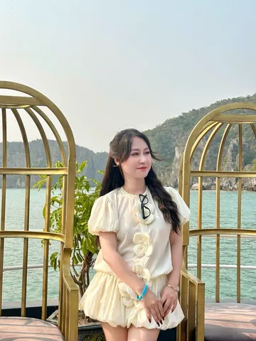 Rose in a white dress by the water