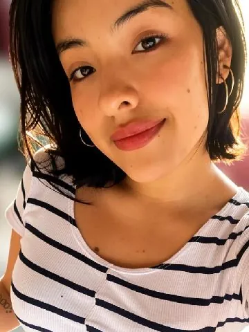 Arii in a striped top, smiling